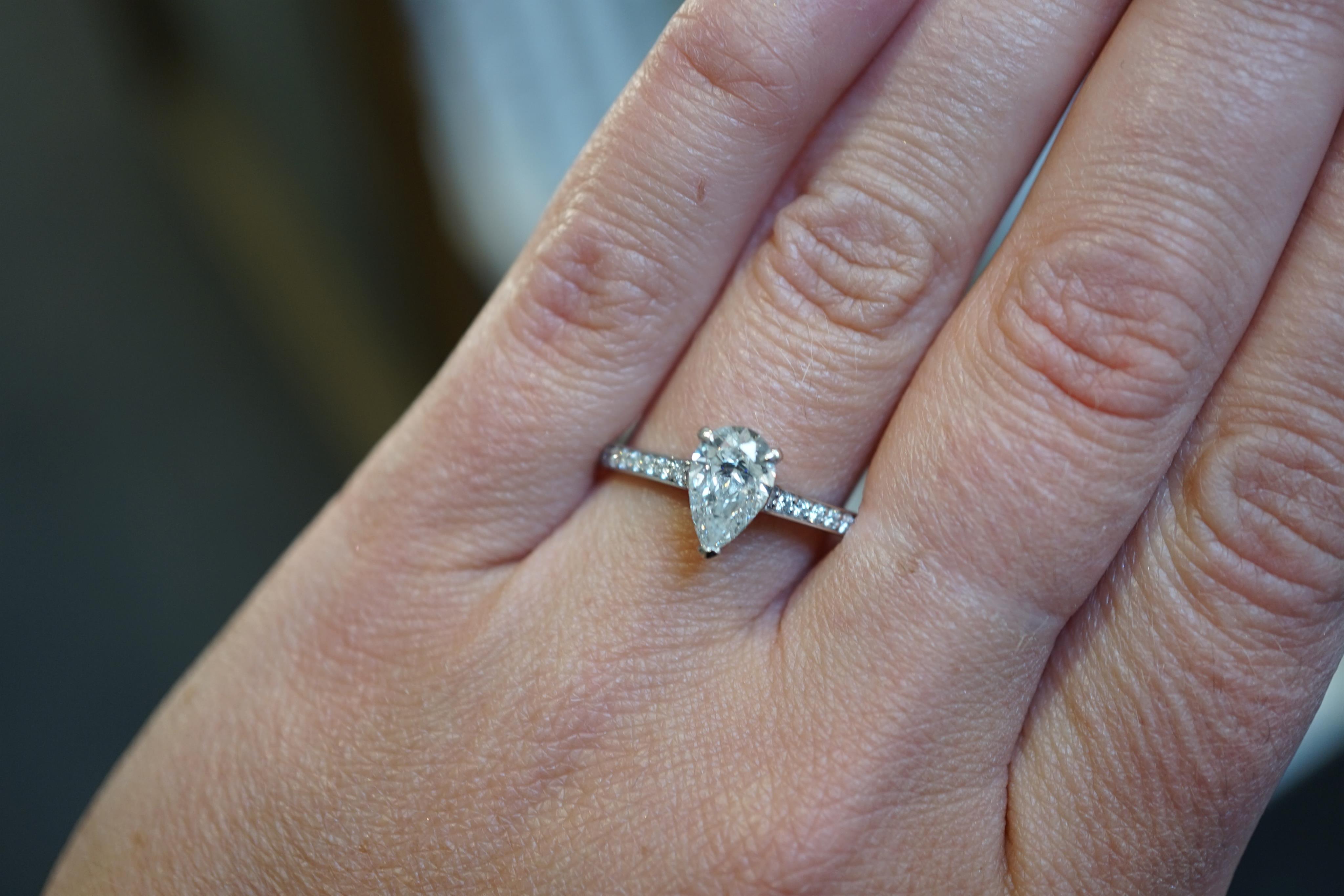 A recent Boodles platinum and single stone pear cut diamond set Harmony design ring, with diamond chip set shoulders and setting